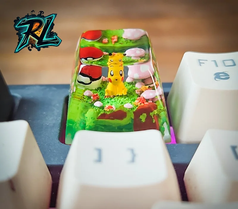 How To Make Custom Keycaps Resin: Easy Guide For Beginners 3 How To Make Custom Keycaps Resin: A miniature Pikachu figurine sitting on a green grass field with tiny Pokéballs inside a crystal clear resin keycap