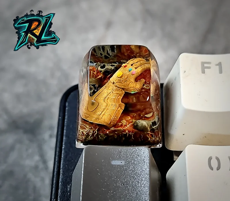 How To Make Custom Keycaps Resin: Easy Guide For Beginners 4 How To Make Custom Keycaps Resin: Close-up shot of a golden Thanos gauntlet model with vibrant infinity stones crafted inside a clear mechanical keyboard keycap