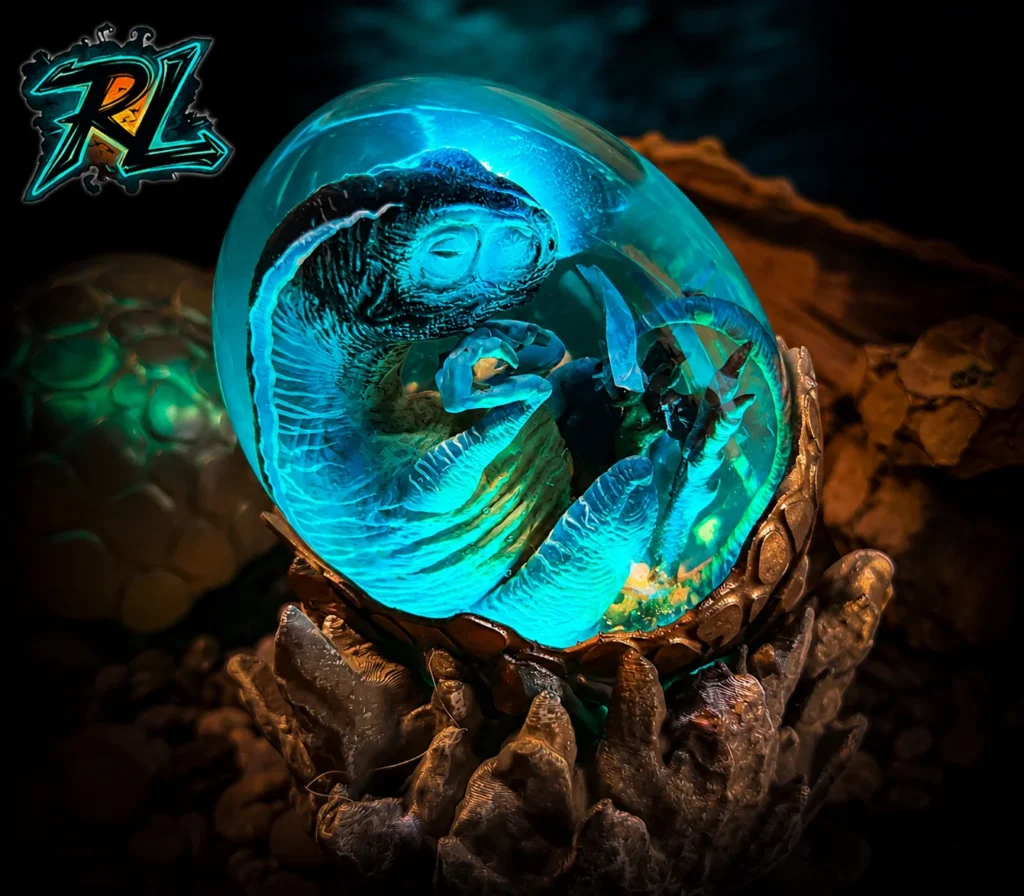 Table Lamp Ideas For Bedroom: Top Beautiful Warm Lights 5 A prehistoric raptor egg resin lamp glowing on a metallic base, offering bold table lamp ideas for bedroom styling with its detailed hand-painted dinosaur diorama